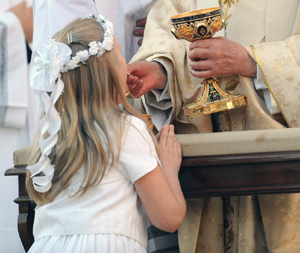 GIRL KNEELS AS SHE RECEIVES COMMUNION FROM POPE